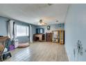 Bright living room featuring wood-look floors and a ceiling fan at 429 Chateau Dr, Henderson, NV 89002