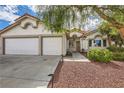 House exterior with three car garage and landscaping at 1153 Gallant Fox Ave, Henderson, NV 89015