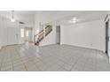 Spacious living room with tiled floors and a staircase at 3825 Pink Frost Dr, North Las Vegas, NV 89032