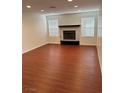 Living room with hardwood floors and a fireplace at 9417 Amber Valley Ln, Las Vegas, NV 89134