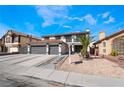 Two-story house with three car garage and landscaping at 7869 Salt Spray Ct, Las Vegas, NV 89139