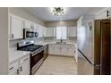 Modern kitchen with stainless steel appliances and white cabinets at 1400 Evening Song Ave, Henderson, NV 89012