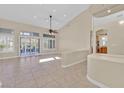 Spacious living room with tile floors, ceiling fan, and large windows at 10032 Hope Island Dr, Las Vegas, NV 89134