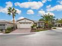 Single-story home with a two-car garage and desert landscaping at 4419 Palloni Ct, Las Vegas, NV 89135