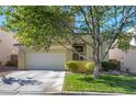 Two-story home with attached garage and manicured lawn at 2033 Shining Feather Ln, Las Vegas, NV 89134