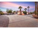 View of the home's garage and long driveway at 4045 W Ford Ave, Las Vegas, NV 89139