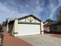 House exterior featuring a two-car garage and a well-maintained front yard at 4438 Galore Ave, Las Vegas, NV 89115