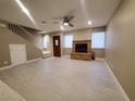 Spacious living room with fireplace and wood-look tile floors at 2678 Aracatuba Ave, Las Vegas, NV 89121