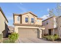 Two-story house with tan siding and a two car garage at 7052 Coventry Glenn Rd, Las Vegas, NV 89148