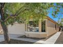 Tan house with beige garage door and a walkway at 4599 Ordway Dr, Las Vegas, NV 89139