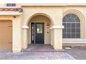 Elegant front entrance with arched entryway and black door at 10052 Baystone St, Las Vegas, NV 89141