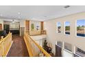 Upstairs hallway with built-in bookshelves and views to the living room below at 11132 Ferragamo Ct, Las Vegas, NV 89141