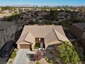 Single-story home with a tile roof and a city view in the background at 3324 Tranquil Garden St, Las Vegas, NV 89117