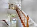 Elegant wooden staircase with a beige carpet runner at 11837 Luna Del Mar Ln, Las Vegas, NV 89138