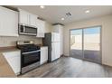 Kitchen with stainless steel appliances and backyard access at 4249 Gold Desert St, North Las Vegas, NV 89032