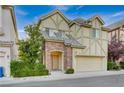 Two-story house with stone accents and attached garage at 9209 Dalmahoy Pl, Las Vegas, NV 89145