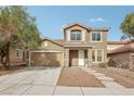 Two-story house with tan exterior, attached garage, and landscaped yard at 1006 Pecos River Ave, Henderson, NV 89002