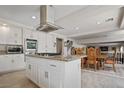 Kitchen features island, stainless steel appliances, and view into dining area at 4416 Lilac Glen Dr, Las Vegas, NV 89129