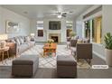 Virtually staged living room with fireplace and large windows at 7942 Quail Mountain Ln, Las Vegas, NV 89131