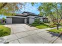 Contemporary home with a large gray garage door and manicured lawn at 1529 Villa Rica Dr, Henderson, NV 89052