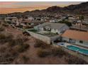 Aerial view of house, pool, and surrounding desert landscape with mountain backdrop at 639 Marina Dr, Boulder City, NV 89005