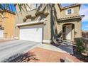 Two-story house with attached garage and landscaped yard at 6476 Chebec St, North Las Vegas, NV 89084