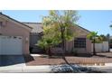 One-story house with a two-car garage and desert landscaping at 8637 Stone Harbor Ave, Las Vegas, NV 89145