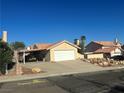 House exterior with a garage and landscaping at 3218 Ocotillo Dr, Laughlin, NV 89029