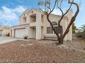 Two-story house with a tree in the front yard at 4712 Wild Oak Way, North Las Vegas, NV 89031