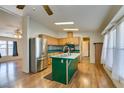 Kitchen with island, stainless steel appliances, and laminate flooring at 311 Sir George Dr, Las Vegas, NV 89110