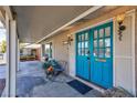 Inviting front porch with teal doors and seating area at 2008 Franklin Ave, Las Vegas, NV 89104