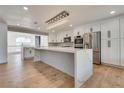 Modern kitchen with white cabinets, large island, and stainless steel appliances at 9108 Sapphire Ridge Ave, Las Vegas, NV 89129