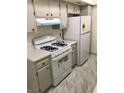 Efficient kitchen, features white appliances and light grey cabinets at 1440 Vegas Valley Dr # 6, Las Vegas, NV 89169