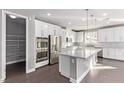 Modern kitchen featuring white cabinets, stainless steel appliances, and an island at 8797 Pinley Spring St, Las Vegas, NV 89113