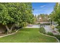 Landscaped backyard featuring a pool, patio, and lounge chairs at 390 Rushing Creek Ct, Henderson, NV 89014