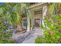 Front entry with lush landscaping, a walkway, and a charming door at 390 Rushing Creek Ct, Henderson, NV 89014