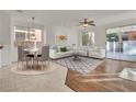 Virtually staged dining area and living room combination with hardwood floors at 5413 Carnation Meadow St, Las Vegas, NV 89130