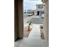 View of the street and neighboring houses from the front walkway at 3626 Via Del Robles Ave, Las Vegas, NV 89115