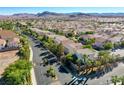 Aerial view showing community, surrounding landscape, and mountain views at 8824 Traveling Breeze Ave # 101, Las Vegas, NV 89178