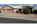 Single-story house with three-car garage and desert landscaping at 6824 Little Brook St, Las Vegas, NV 89131