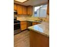 Kitchen features granite countertops, stainless steel appliances, and wood cabinets at 5837 Goodsprings Ct, Las Vegas, NV 89110