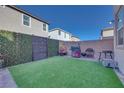 Artificial turf backyard with grill and privacy fence at 7294 Copper Grove Ave, Las Vegas, NV 89113