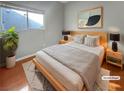 Virtually staged bedroom with light gray walls and hardwood floors at 771 Thorton Beach St, Henderson, NV 89015