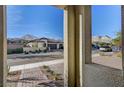 View of the street and surrounding homes from covered entry at 288 Forsyth Park St, Las Vegas, NV 89138