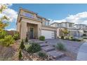 Two-story home with a white garage door and landscaped front yard at 12429 Alpenglow Ct, Las Vegas, NV 89138