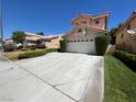 Two-story house with a two-car garage and a large driveway at 8236 Bermuda Beach Dr, Las Vegas, NV 89128