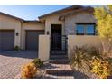 Welcoming entryway with a black metal gate and stone accents at 169 Bella Noche St, Las Vegas, NV 89138