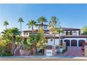 Stunning two-story home with palm trees and a large driveway at 8 Rue Mediterra Dr, Henderson, NV 89011