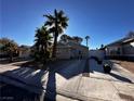 Single-story home exterior with a driveway and palm trees at 6807 Sebring St, Las Vegas, NV 89103