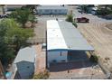 An elevated view of a manufactured home with a storage shed and fenced backyard at 1240 S Comstock Cir, Pahrump, NV 89048